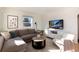 Bright living room featuring a sofa, mounted TV, natural light, and modern decor at 4920 Clay St, Denver, CO 80221