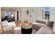 Open-concept living room with a modern sofa, light-colored walls, and access to the dining area at 4920 Clay St, Denver, CO 80221