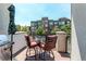 Inviting balcony with dining set, grill, and views of the building and surrounding landscape at 8361 Parkland St, Broomfield, CO 80021