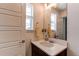 Bright bathroom featuring a well-lit vanity area with decorative fixtures, neutral paint at 8361 Parkland St, Broomfield, CO 80021
