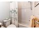 Clean bathroom showcases a tub and shower combo with stylish tile and a decorative shower curtain at 8361 Parkland St, Broomfield, CO 80021
