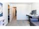 Bright bedroom featuring a work space and view into the closet and hallway at 8361 Parkland St, Broomfield, CO 80021