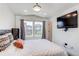 Bright bedroom features large windows, neutral walls, and a modern ceiling fan at 8361 Parkland St, Broomfield, CO 80021