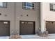 A row of townhouse-style garages with dark-colored doors and modern facades at 8361 Parkland St, Broomfield, CO 80021
