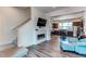 Bright living room with a fireplace, open to kitchen and dining area at 8361 Parkland St, Broomfield, CO 80021