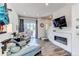 Open-concept living room featuring a cozy fireplace and stylish furnishings at 8361 Parkland St, Broomfield, CO 80021