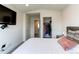 Relaxing bedroom featuring a TV, comfortable bed, and view into the closet at 8361 Parkland St, Broomfield, CO 80021