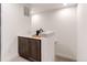 Convenient wet bar area features a countertop, storage cabinets, and space for a mini fridge at 8361 Parkland St, Broomfield, CO 80021