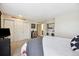 Spacious bedroom features plush carpeting, a large closet, a laundry closet, and a comfortable bed at 3343 S Monaco Pkwy # A, Denver, CO 80222