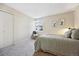 Well-lit bedroom with a soft rug, cozy reading nook with a plush pillow, and soft bedding at 3343 S Monaco Pkwy # A, Denver, CO 80222