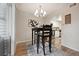 Dining area adjacent to kitchen, with an open floor plan and contemporary chandelier at 3343 S Monaco Pkwy # A, Denver, CO 80222