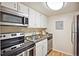 Efficient kitchen with stainless steel appliances and white cabinetry at 3343 S Monaco Pkwy # A, Denver, CO 80222