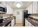 Compact kitchen featuring stainless steel appliances and ample storage space at 3343 S Monaco Pkwy # A, Denver, CO 80222