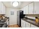 Functional kitchen with stainless steel appliances and white cabinets at 3343 S Monaco Pkwy # A, Denver, CO 80222