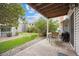 Back patio features covered ceiling, rock landscape, and green grass at 3343 S Monaco Pkwy # A, Denver, CO 80222