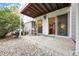 Back patio with sliding door into unit, rock landscape, and concrete ground at 3343 S Monaco Pkwy # A, Denver, CO 80222