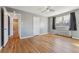 A bedroom featuring hardwood floors, painted walls, a ceiling fan, and a doorway to the bathroom at 525 Jackson St # 304, Denver, CO 80206