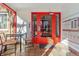 Building entrance with a red door, brick accents and a small seating area to greet guests at 525 Jackson St # 304, Denver, CO 80206