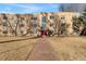 Charming brick apartment building featuring a bright red entryway and landscaped lawn at 525 Jackson St # 304, Denver, CO 80206