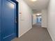 A long hallway with unit numbers and doors leading to apartments and an exit sign at 525 Jackson St # 304, Denver, CO 80206