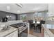 Open concept kitchen with granite countertops, stainless steel appliances, and eat-in dining area at 525 Jackson St # 304, Denver, CO 80206