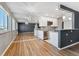 Modern kitchen flowing into living area with sleek appliances and granite countertops at 525 Jackson St # 304, Denver, CO 80206