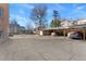 Cars are seen parked under a covered parking structure on a sunny day with blue sky at 525 Jackson St # 304, Denver, CO 80206