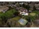 Aerial view of a luxurious home with a pool, sports court, and meticulously landscaped grounds at 4475 S Downing St, Cherry Hills Village, CO 80113