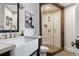 Modern bathroom featuring a glass-enclosed shower with tile surround and a farmhouse sink at 4475 S Downing St, Cherry Hills Village, CO 80113