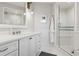 Bathroom featuring a vanity with quartz countertop and a glass enclosed shower at 4475 S Downing St, Cherry Hills Village, CO 80113