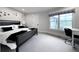 Bedroom with a black bed, large window and desk area featuring minimalist decor and ample natural light at 4475 S Downing St, Cherry Hills Village, CO 80113