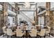 Formal dining room with stone accents, modern chandelier, and access to staircase at 4475 S Downing St, Cherry Hills Village, CO 80113
