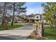 Grand home entrance with a circular driveway, stone gateposts, and manicured landscaping at 4475 S Downing St, Cherry Hills Village, CO 80113