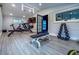 Home gym with rowing machine, exercise bike, weights and TV for workout at 4475 S Downing St, Cherry Hills Village, CO 80113