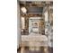 Hallway featuring decorative stone columns, hardwood floors, and curated decor at 4475 S Downing St, Cherry Hills Village, CO 80113