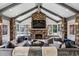 Inviting living room with a stone fireplace, vaulted ceilings, and large windows offering an abundance of natural light at 4475 S Downing St, Cherry Hills Village, CO 80113