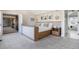 Main bedroom featuring a king bed with soft gray accents and a hallway leading to a bathroom at 4475 S Downing St, Cherry Hills Village, CO 80113