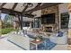 Inviting outdoor living space with stone fireplace, comfortable seating, and covered patio area at 4475 S Downing St, Cherry Hills Village, CO 80113