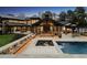 Outdoor living area featuring a pool, hot tub, fireplace, and seating area, ideal for entertaining at 4475 S Downing St, Cherry Hills Village, CO 80113