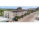 Street view of a multi-story apartment building with balconies, street trees, and mountain views in the distance at 277 N Broadway # 403, Denver, CO 80203