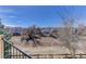 A scenic backyard view includes a wooden fence, homes, and foliage, providing privacy and a sense of community at 22388 Quail Run Dr, Parker, CO 80138