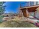 Backyard view of the house with wooden support beams and stairs at 22388 Quail Run Dr, Parker, CO 80138