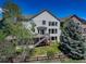 Expansive backyard featuring a deck, lush landscaping, and views of the surrounding greenery at 22388 Quail Run Dr, Parker, CO 80138