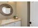 Cozy bathroom with round mirror and decorative accents at 22388 Quail Run Dr, Parker, CO 80138