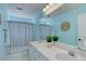 Bright bathroom with double sinks, and a shower with a curtain at 22388 Quail Run Dr, Parker, CO 80138