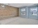 Bedroom with an accent wood paneled wall, light blue painted walls, carpet, and two windows at 22388 Quail Run Dr, Parker, CO 80138
