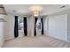 Bedroom with carpet, two windows with dark curtains, and a closet with white doors at 22388 Quail Run Dr, Parker, CO 80138