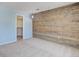 Bedroom with carpet, wood paneled wall, and a walk in closet with shelving at 22388 Quail Run Dr, Parker, CO 80138