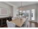 Elegant dining room with chandelier, stylish furnishings, and access to outdoor patio at 22388 Quail Run Dr, Parker, CO 80138