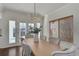 Charming dining area with modern chandelier, hardwood floors, and bright natural light at 22388 Quail Run Dr, Parker, CO 80138